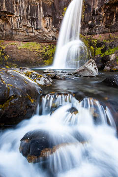 Prándarstadirfoss waterfall, which flows into a stream that flows into Botnsvogur (a cove), Iceland